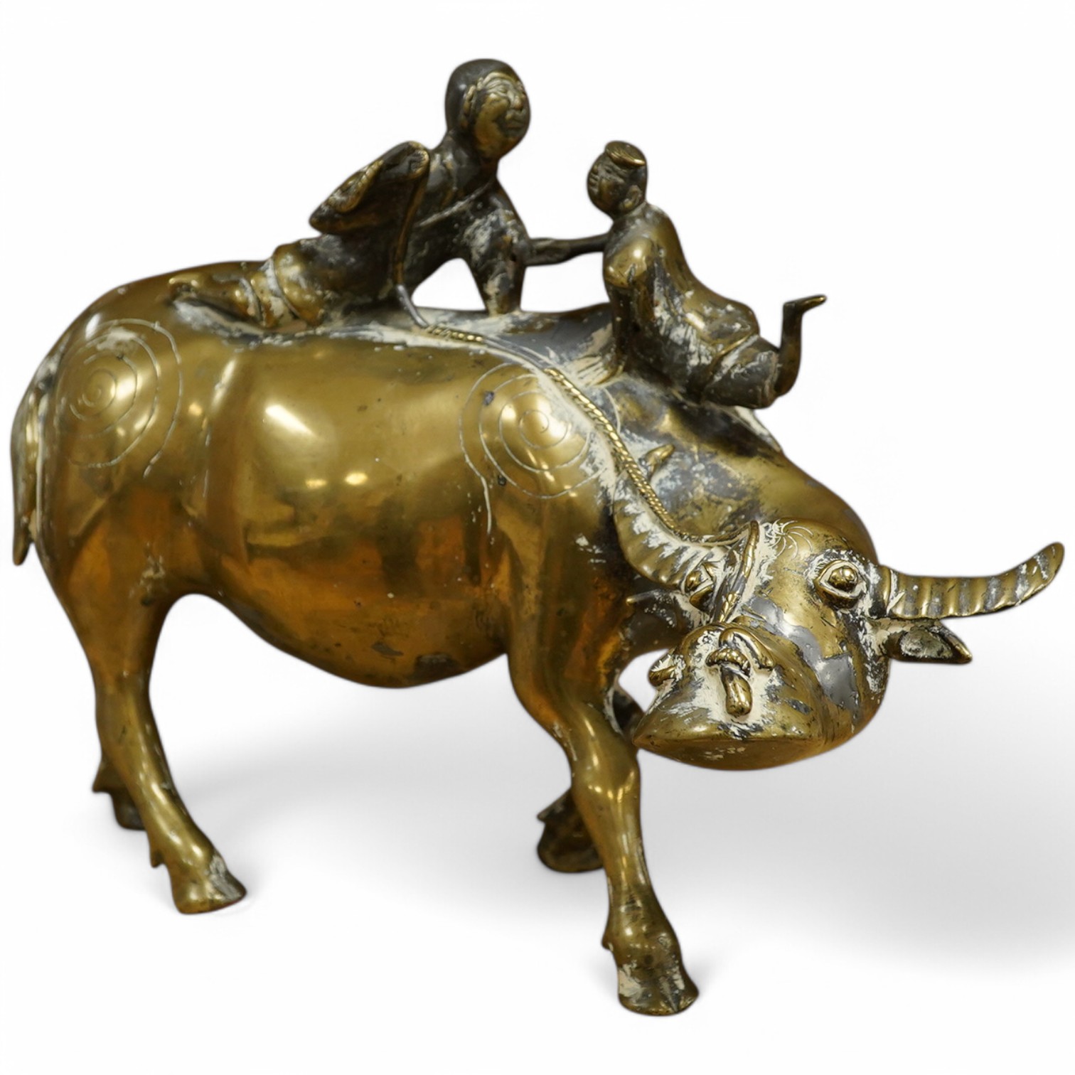 A Chinese bronze and lead model of an ox with two riders, 25cm high. Condition - fair